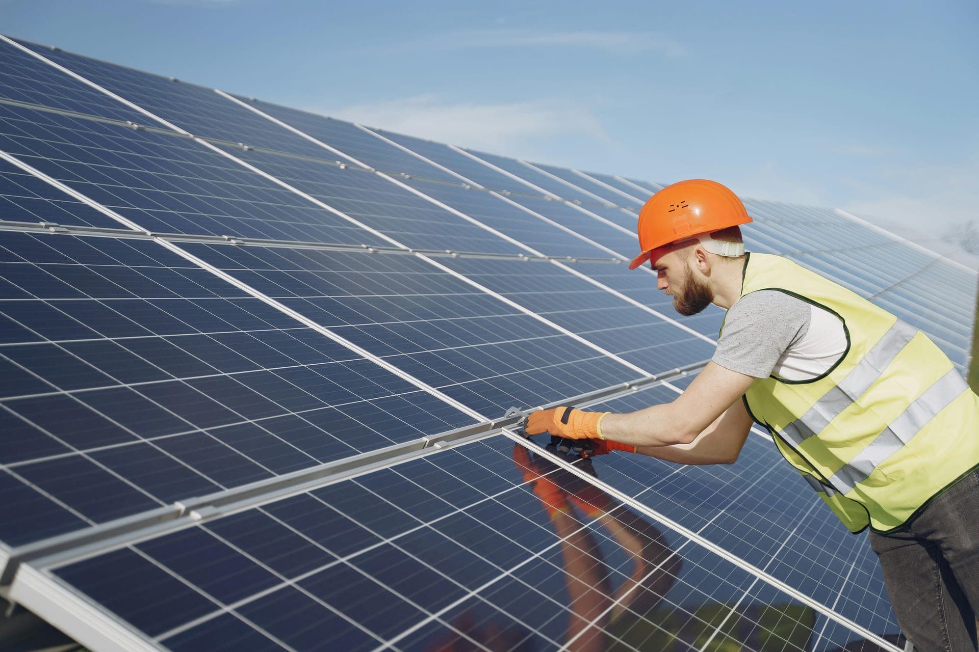 Solar panels on industrial rooftop at sunset