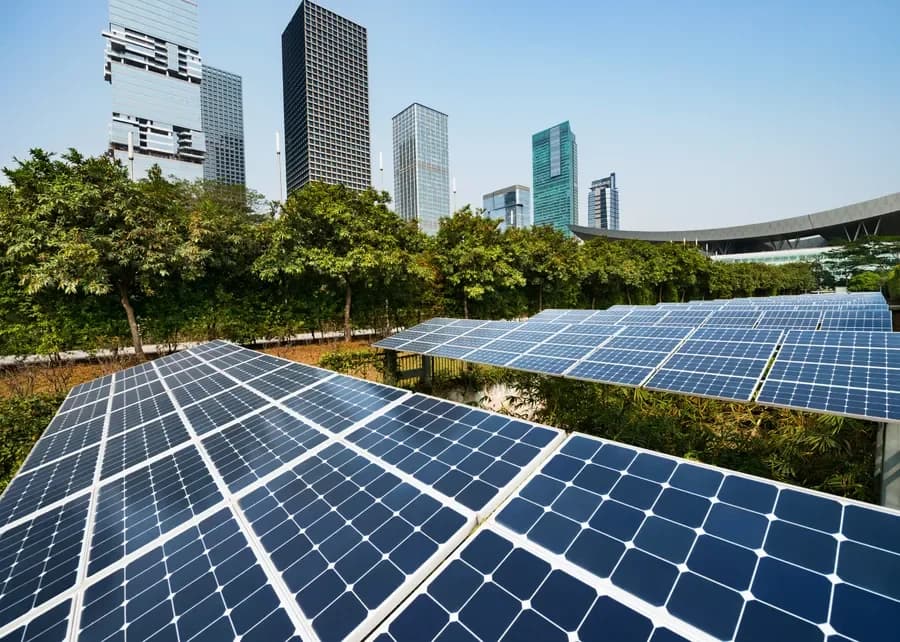 Solar panels on industrial rooftop at sunset